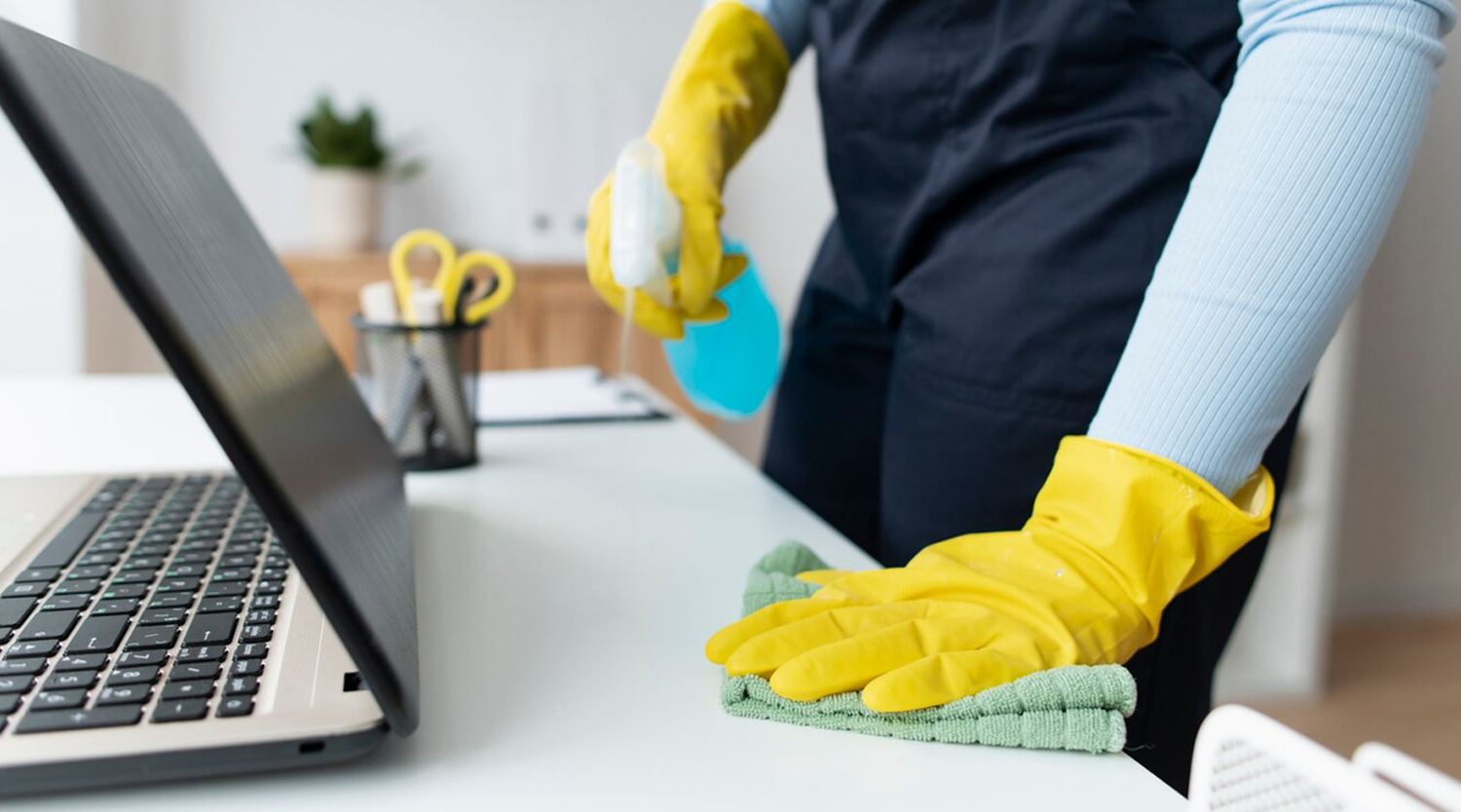  Male Cleaner cleaning a conferance table